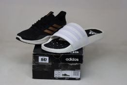 A pair of as new Adidas Fluidflow trainers (UK 5.5) and a pair of Adidas Adilette sliders (UK 13).