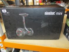A boxed Ninebot mini personal transportation robot powered by Segway in black/red (PN: N3M320).