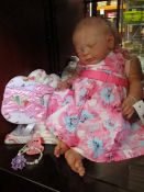 An as new weighted real life look alike baby girl doll.