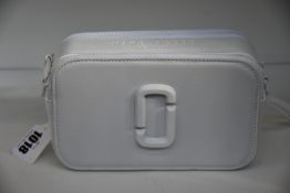 An as new Marc Jacobs camera bag in white.