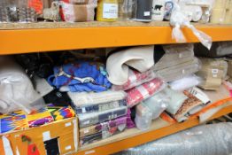 A large quantity of soft home furnishings to include curtains, blankets, throws and related items.