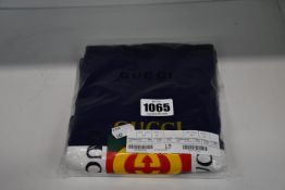 A child's as new Gucci blue and white logo one-piece (9-12 months).