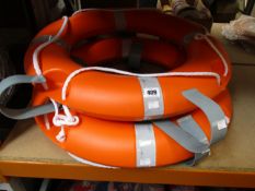 Two EVAL lifebuoys/life rings and two metal support brackets.