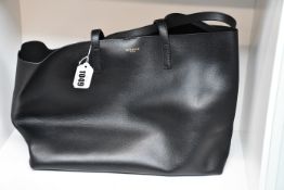 An as new Versace logo embossed black leather handbag (RRP £740).