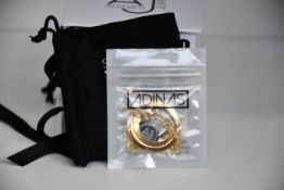 Four items of as new Adina's Jewels jewellery; a Pavé Snake Ear Cuff X Huggie earring combo set (RRP