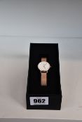 A women's boxed as new Daniel Wellington Petite Melrose, rose gold watch.