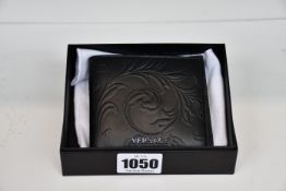 An as new Versace black leather wallet (RRP £230).