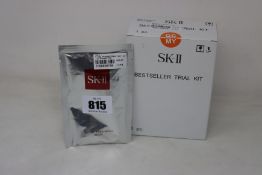 An as new SK-II four piece travel set and one facial treatment mask.