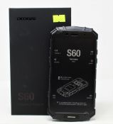 A boxed as new Doogee S60 64GB Rugged Smartphone in Mineral Black (Box opened, UK plug adaptor