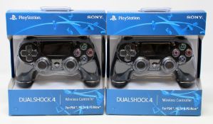 Two boxed as new Sony PlayStation DualShock 4 Wireless Controllers in Black.