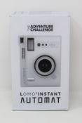 A boxed as new The Adventure Challenge & Lomography Lomo Automat Instant Camera (Box opened, some