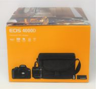 A boxed as new Canon EOS 4000D Travel Kit including; a Canon EOS 4000D Camera Body, a Canon EF-S