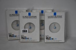 Four boxed as new La Roche-Posay My Skin Track UV wearable sensors.