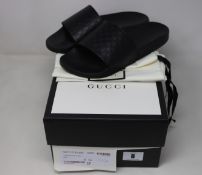 A pair of as new Gucci sliders (Size 6?).