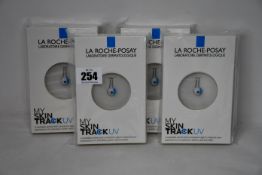 Four boxed as new La Roche-Posay My Skin Track UV wearable sensors.
