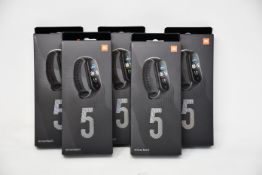 Five boxed as new Xiaomi Mi Smart Band 5 Fitness Trackers in black.