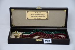 A set of three Tan Tespih prayer beads in brown case.