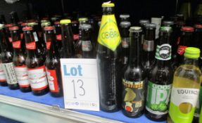 A shelf of assorted beers\ciders\ales to include Budweiser, Peaky Blinders IPA, Cobra and Cools