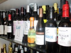 A shelf of assorted wines and champagnes to include Casillero del Diablo, Telescopico, Rioja Vega