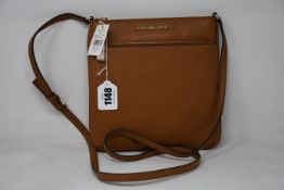 An as new Michael Kors Jet Set flat crossbody bag in acorn.