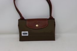 An as new Longchamp Le Pliage 