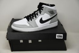 A pair of as new Nike Air Jordan 1 Mid (UK 9 - Distressed box).