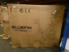 A boxed Bluefin Fitness Tour Spin exercise bike in silver (Item may be incomplete).