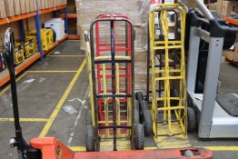 Seven pre-owned sack trucks and a pre-owned pallet truck.