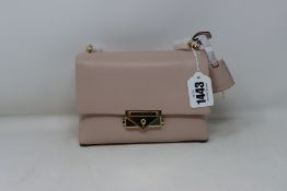An as new Michael Kors Cece XS chain crossbody bag in soft pink.