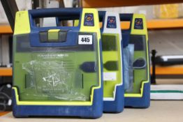 Three Cardiac Science G3 AED trainers.