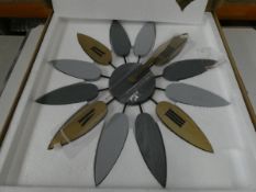 Three floral shaped wall clocks.