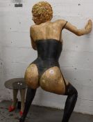 A plaster garden statue of a woman leaning provocatively (Some damage to left hand) and a glass