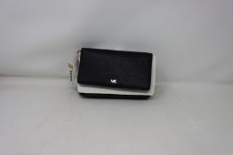 An as new Michael Kors Mott belt bag in black.