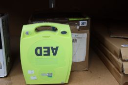 A boxed Zoll AED Plus fully automatic defibrillator with accessories.