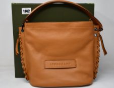 An as new Longchamp Paris crossbody bag in brown.