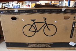 A boxed Fixie Inc floater bicycle in black.