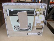 A boxed We R Memory Keepers Typecast typewriter.