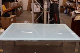 A glass top garden dining table.