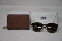 A pair of as new Michael Kors sunglasses and a Michael Kors small dark fawn zip round coin/card