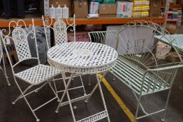 A green garden metal bench and white metal folding bistro garden set.