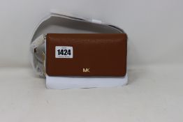 An as new Michael Kors Mott belt bag in brown.