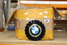A box of BMW style floating wheel caps.