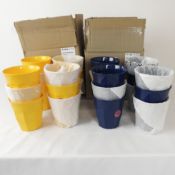 Twelve boxed as new Rice melamine cups in navy blue and twelve Rice melamine cups in yellow