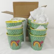 Twelve boxed as new Rice melamine cups in rainbow and stars
