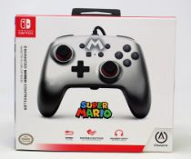 Two boxed as new Nintendo Switch Enhanced Wired Controllers in Mario Silver (Boxes sealed).