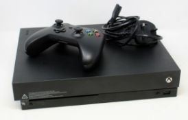 A pre-owned Microsoft Xbox One X 1787 Games Console Black with one Microsoft 1708 wireless