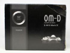A boxed as new Olympus OM-D E-M10 Mark IV 20 MP Micro Four Thirds System Camera in Siver with a M.