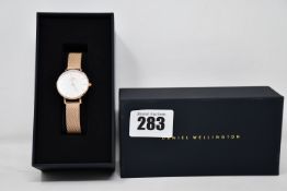 A boxed as new Daniel Wellington Petite Melrose, women's Rose Gold watch.