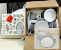 A boxed as new Sevenly 85 piece white porcelain dinner set
