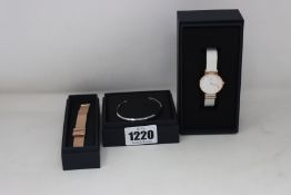 A ladies as new Daniel Wellington white face and strap watch, a ladies Daniel Wellington Gold
